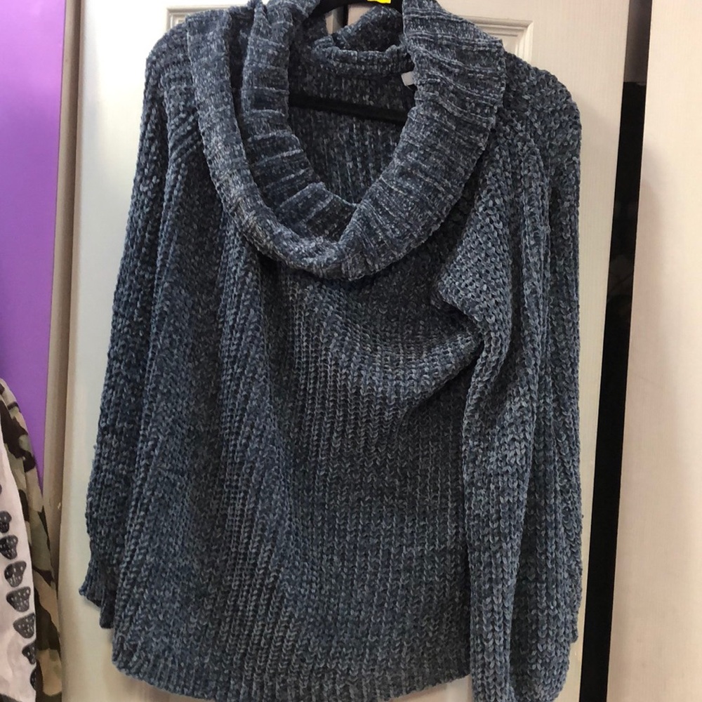 Beautiful woman’s off  the shoulder blue sweater